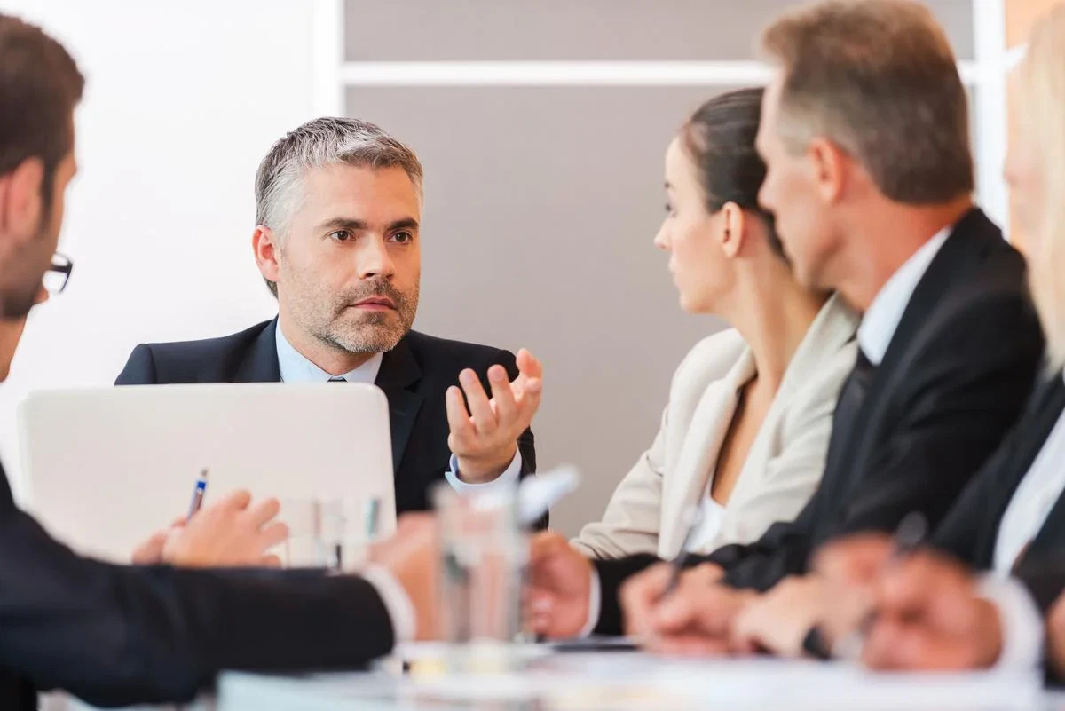 Business people in a meeting discussing administration and liquidation.