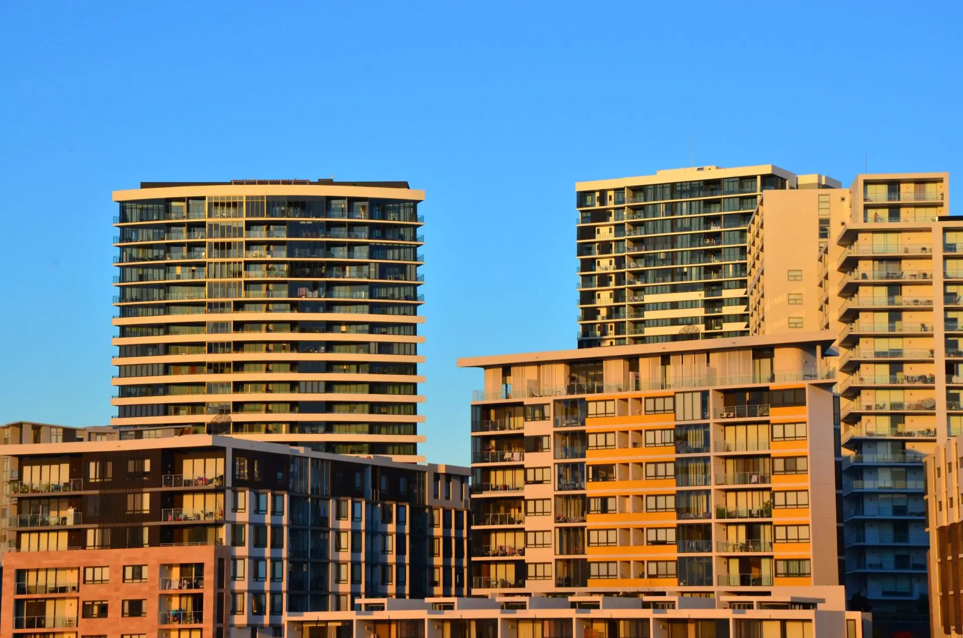 Modern apartment buildings in NSW at sunset. Illustrative of potential building defects.
