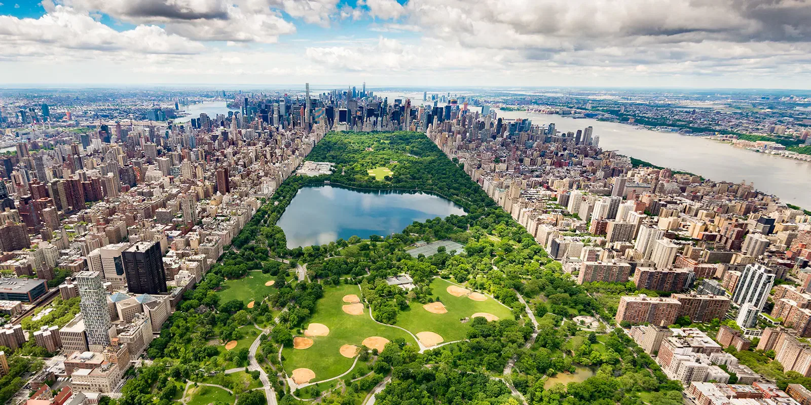 Aerial view of Central Park, Manhattan, NYC. Lush greenery contrasts with surrounding skyscrapers.