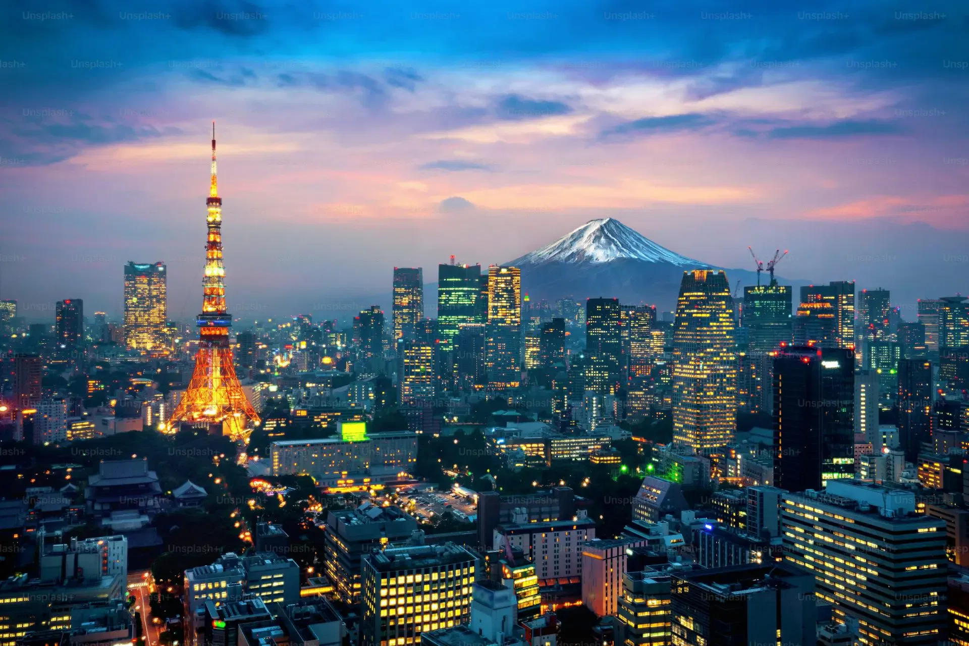 Tokyo skyline at sunset, Mount Fuji in the background.