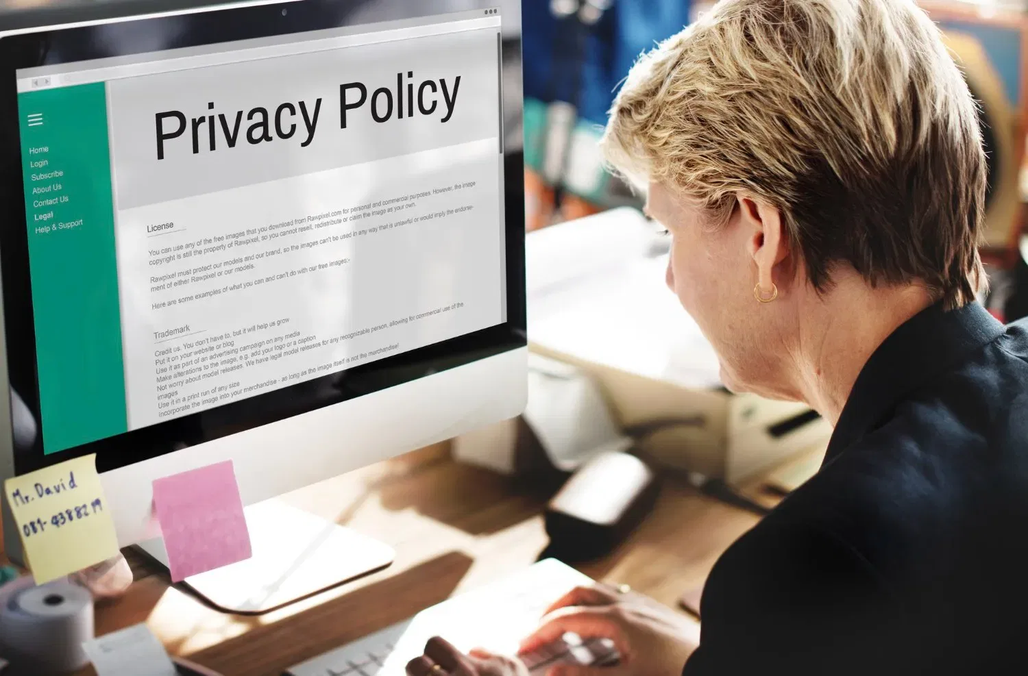 Woman reading privacy policy on computer. Strata debt recovery information.