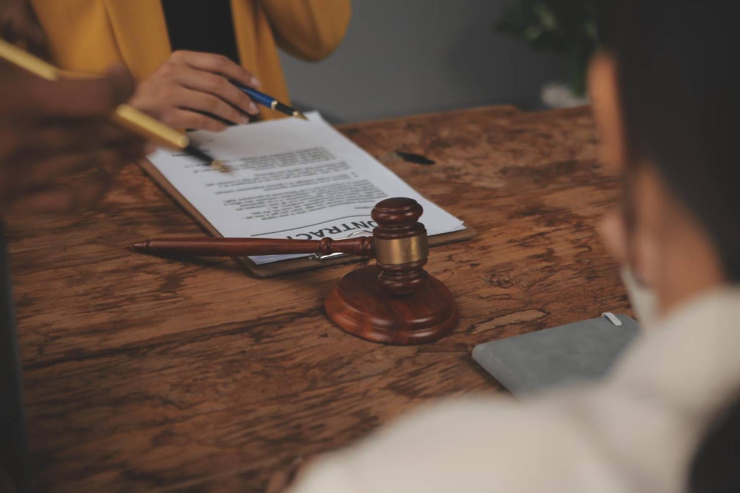 Gavel on a contract. Discussing how to contest a will with legal documents.