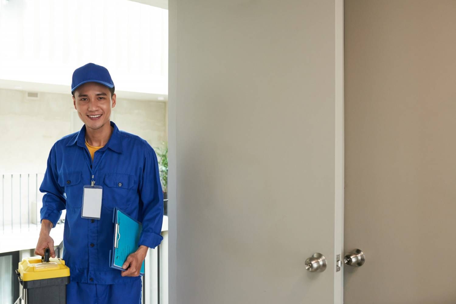 Handyman with toolbox and clipboard, ready to resolve property disputes in mixed-use developments.