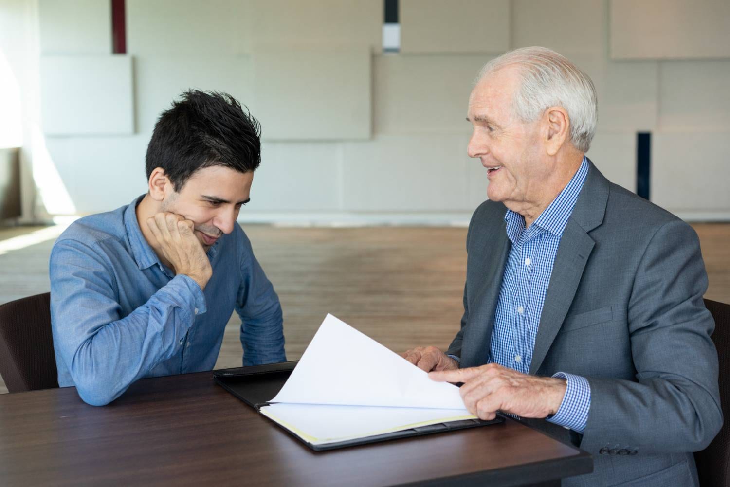 Man reviewing documents with a senior lawyer, possibly discussing will contest time limits in NSW.