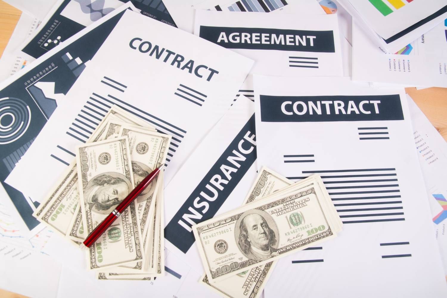 Contracts, agreement, insurance documents, and cash. Financial paperwork.