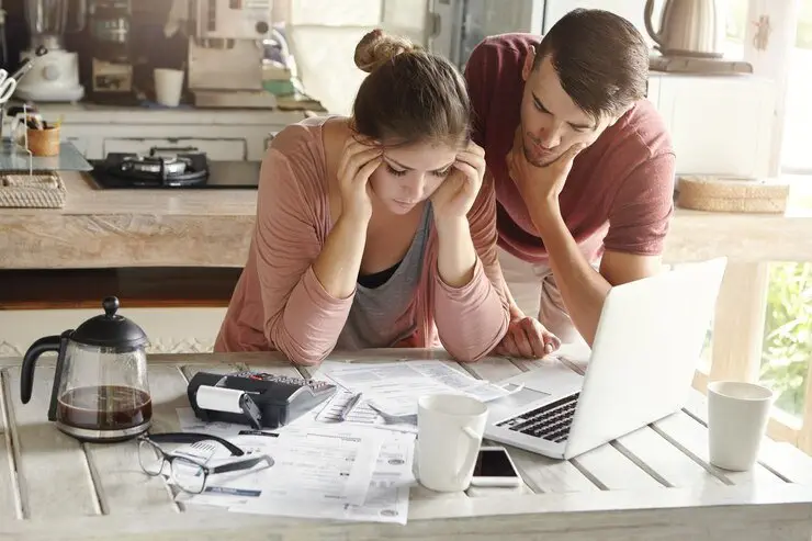 Stressed couple reviewing finances, possibly related to NSW will drafting mistakes.