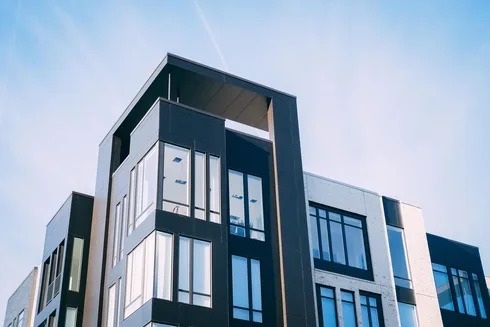 Modern apartment building exterior showcasing large windows.