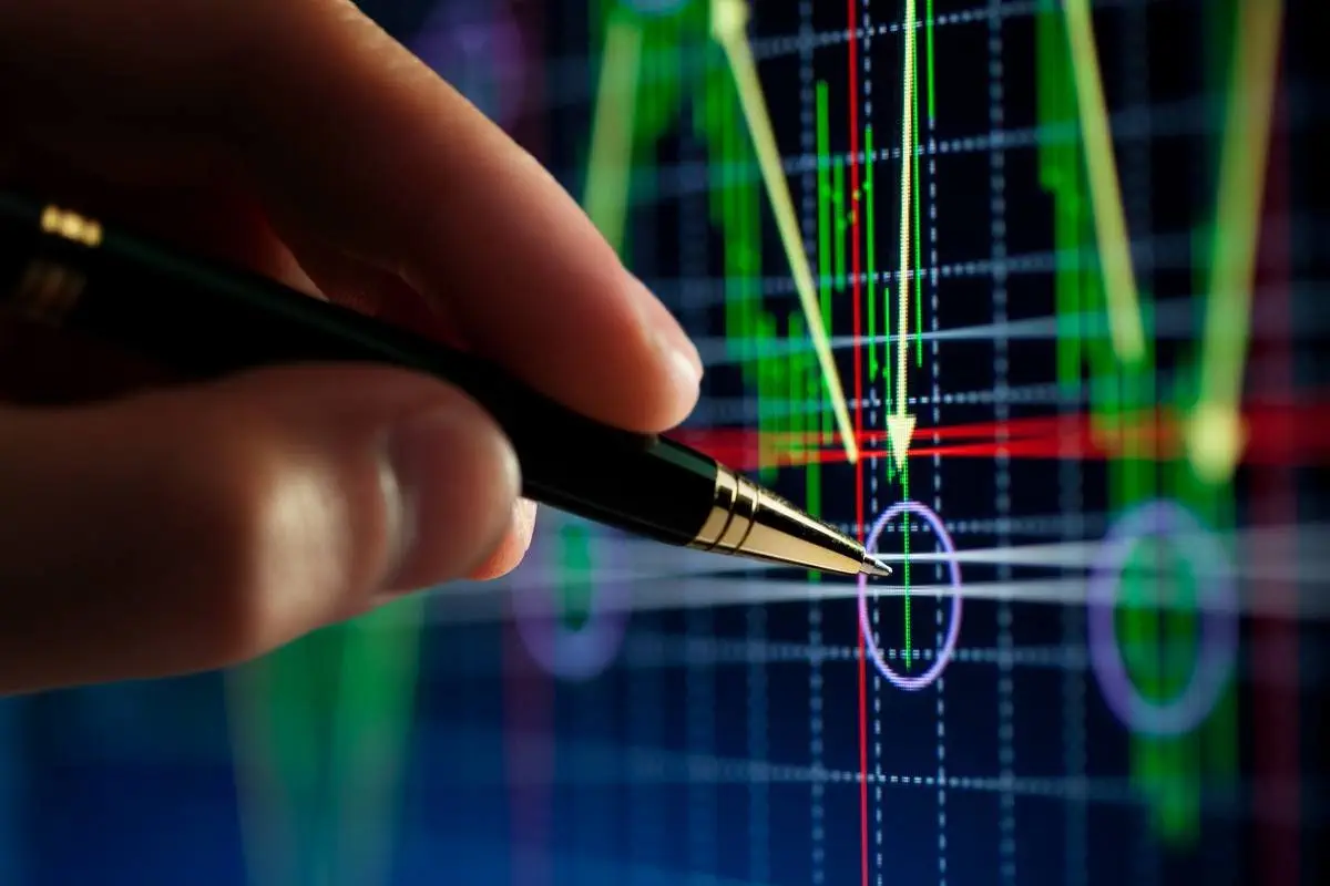 Hand pointing at downward trending stock market graph; business growth strategy