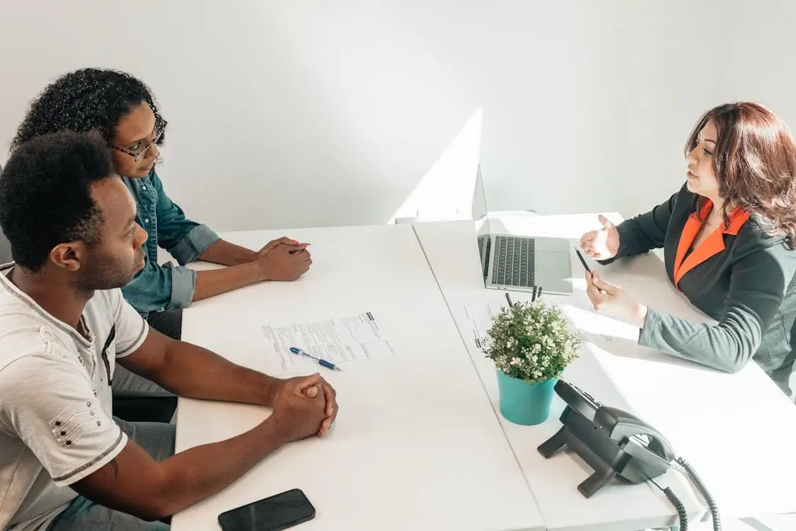 Executor discussing defending a family provision claim in NSW with clients at an office table.