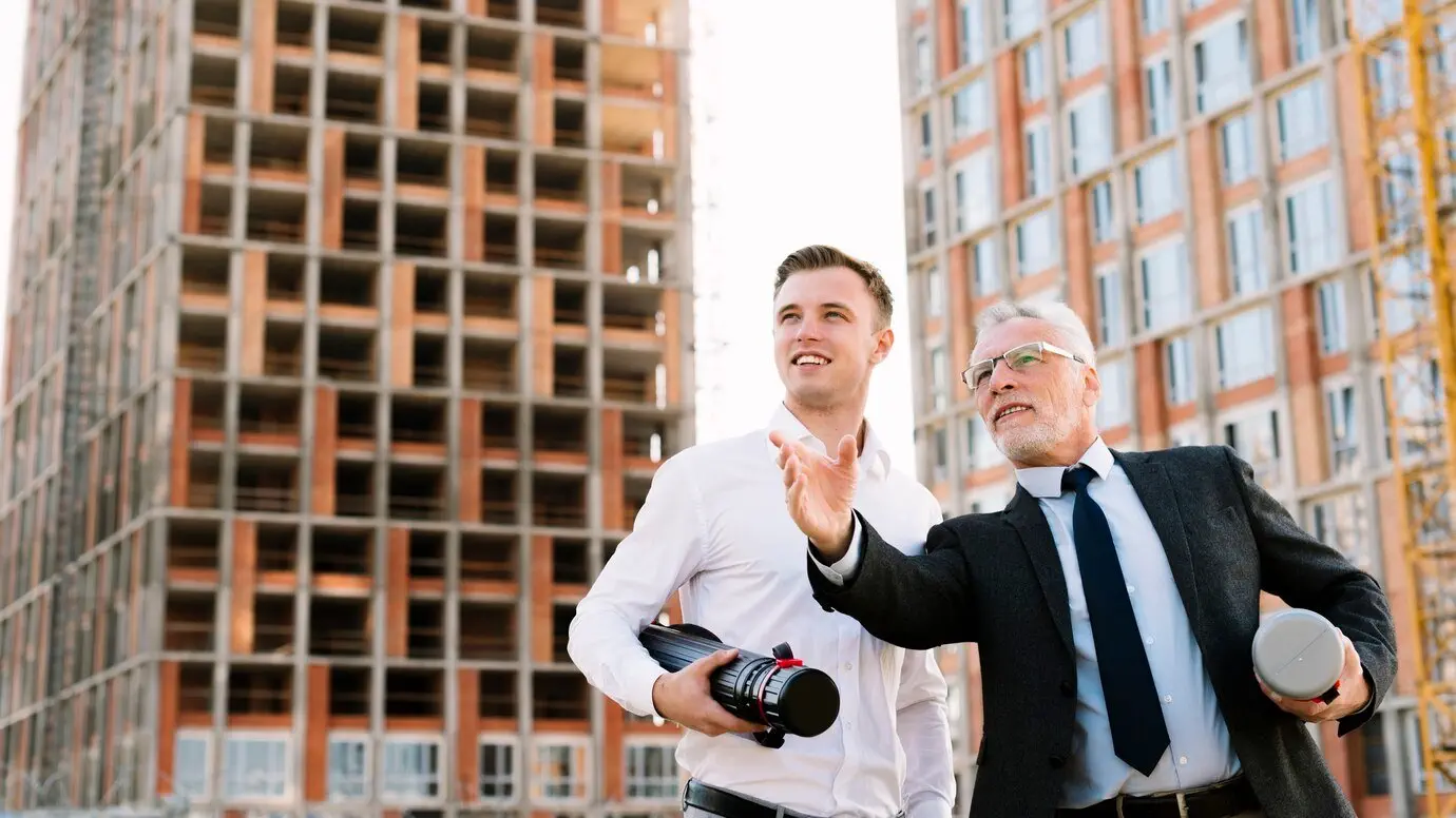 Two architects reviewing building plans at a construction site. NSW Supreme Court building defects.